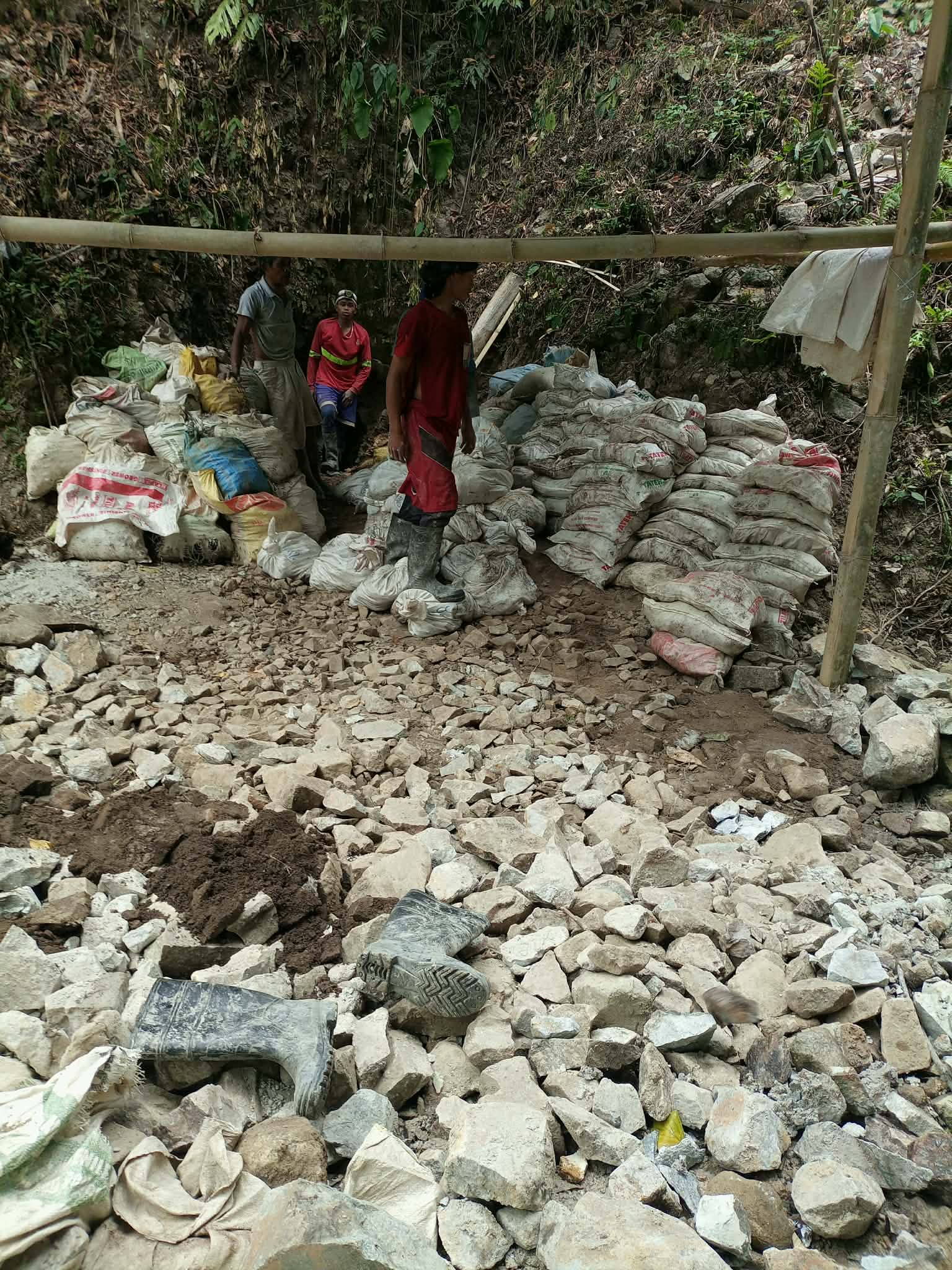 Rows of filled mineral sacks stacked at a field source