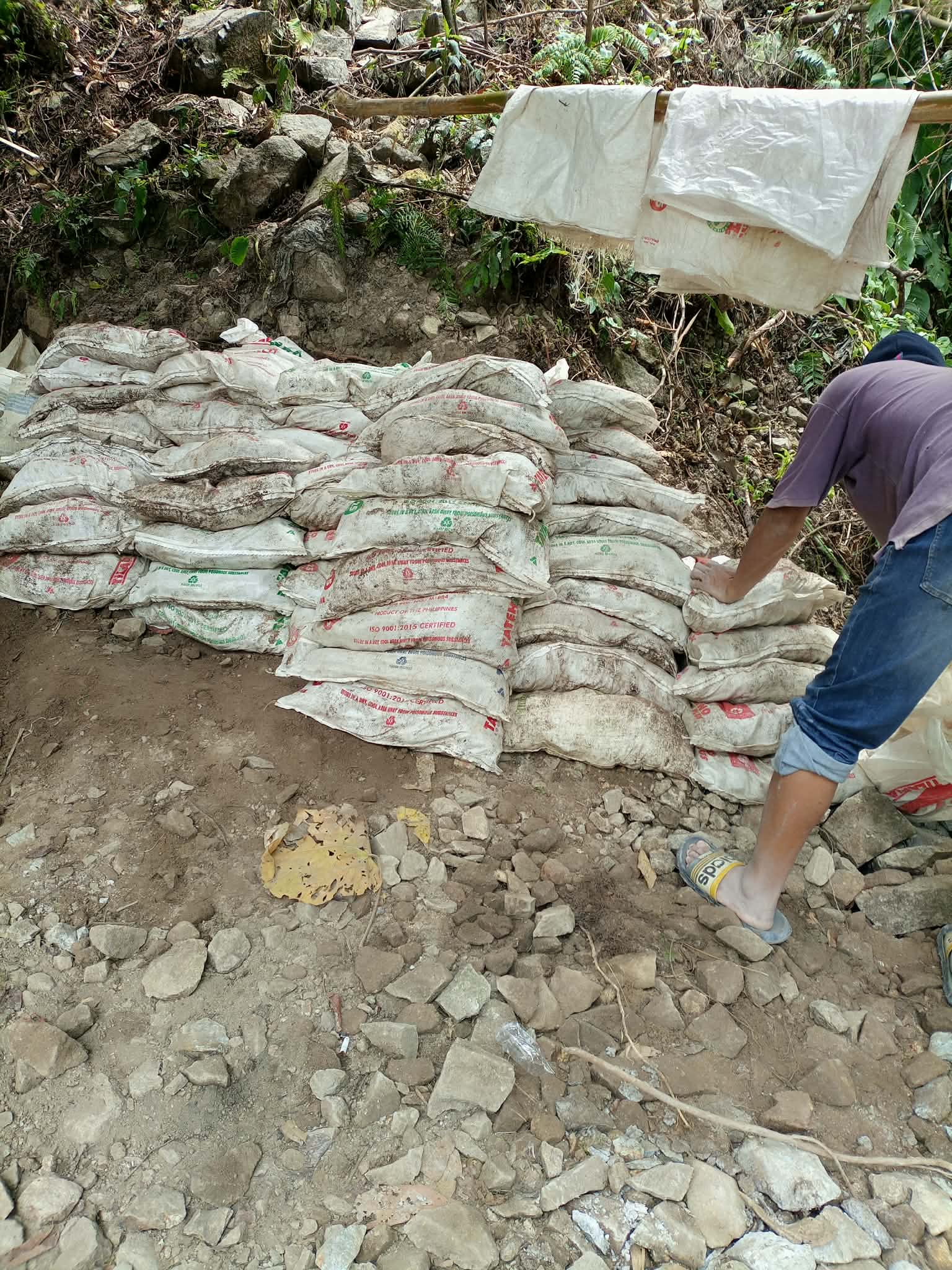 Bagged mineral stock arranged beside a field working area