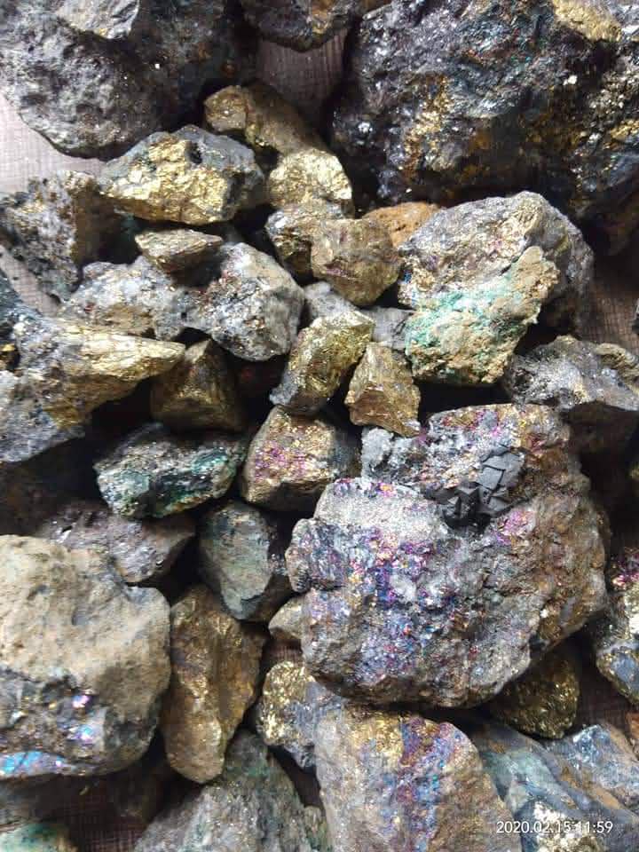 Close view of rough mineral samples with metallic and colored surfaces