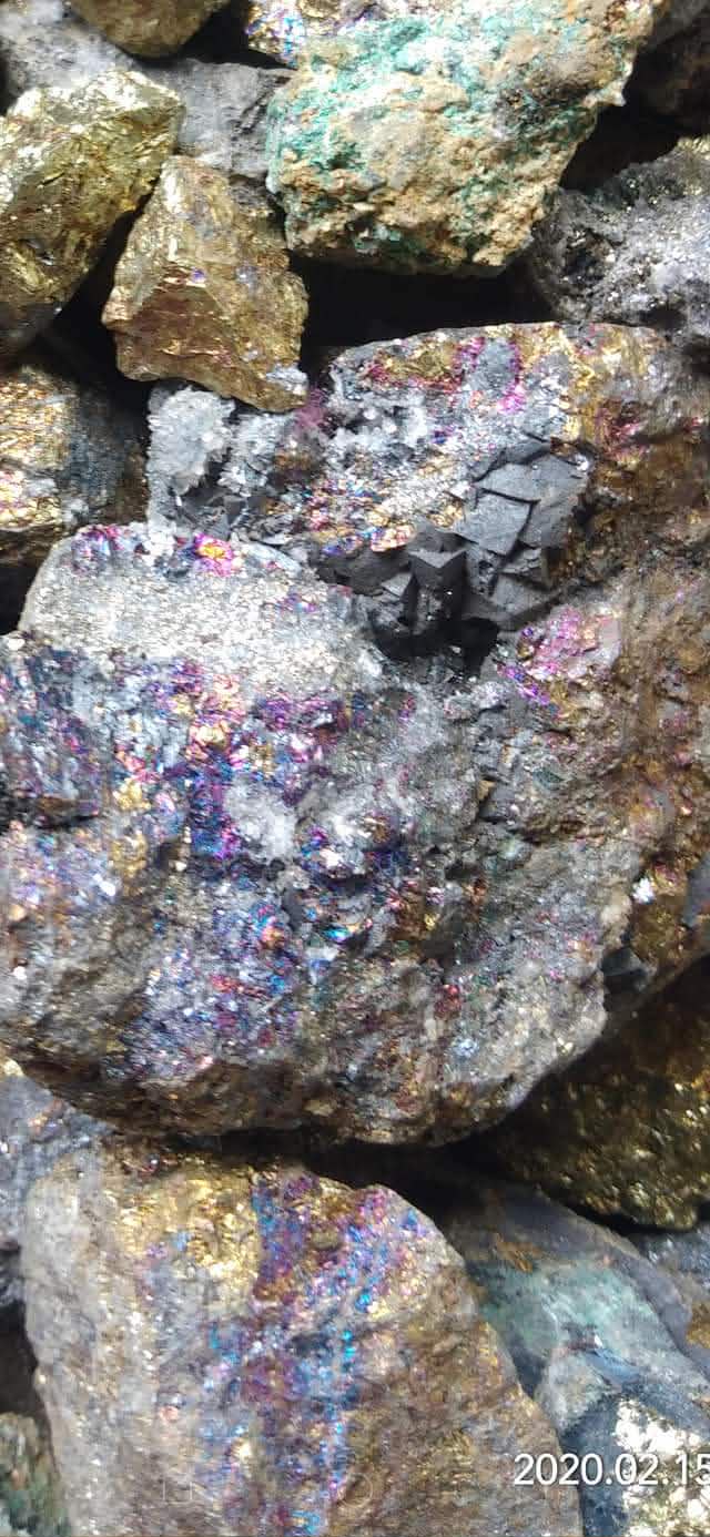 Close view of rough multicolored mineral material from a source lead